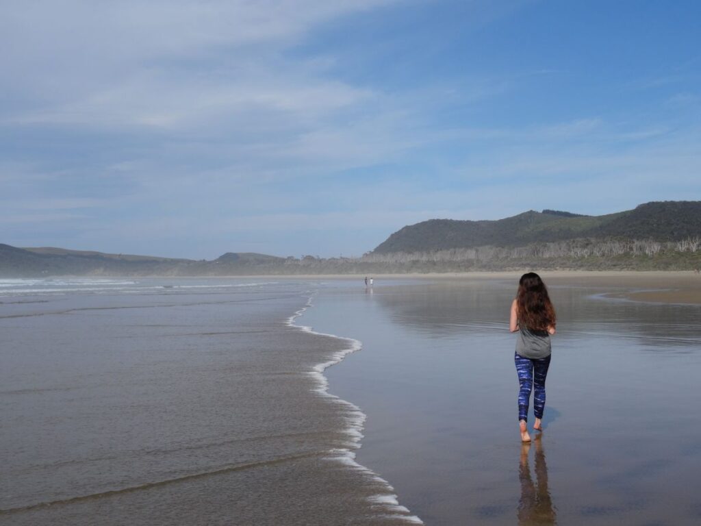 lady walking cathedral caves beach