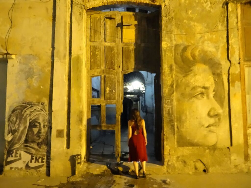 lady old building havana at night