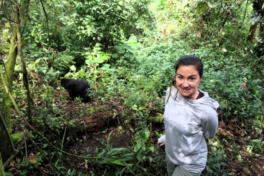 lady posing with gorilla bwindi uganda
