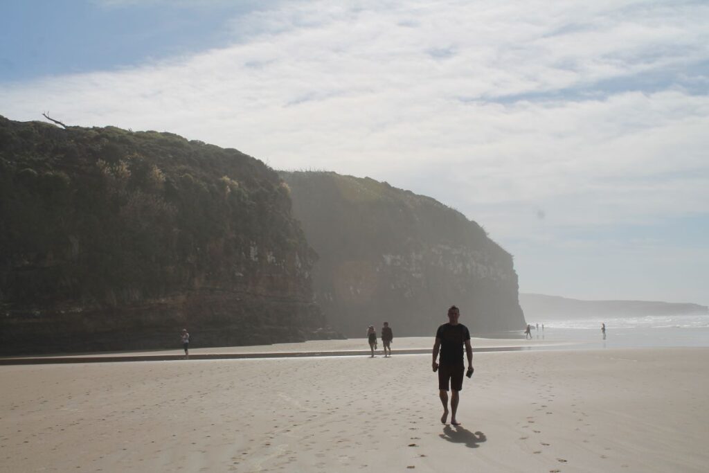 man on beach at cathedral caves