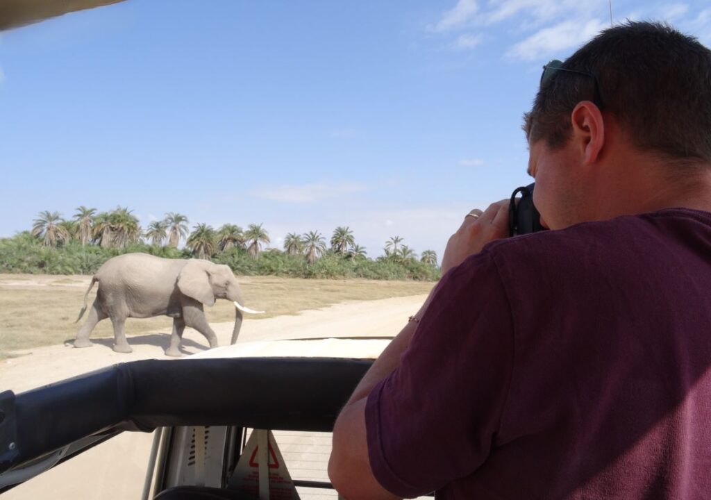 man taking photos amboseli
