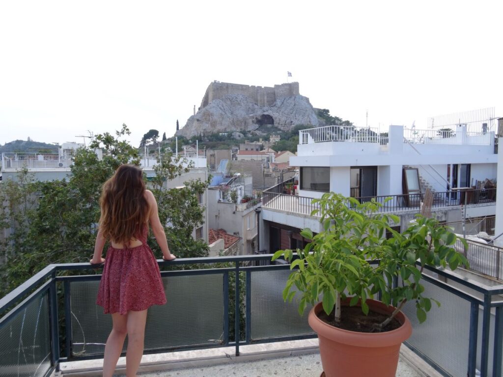 lady on balcony of adams hotel in athens