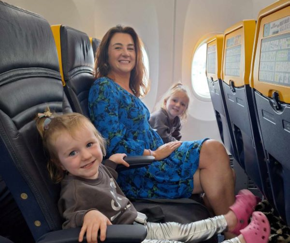 family on board plane posing